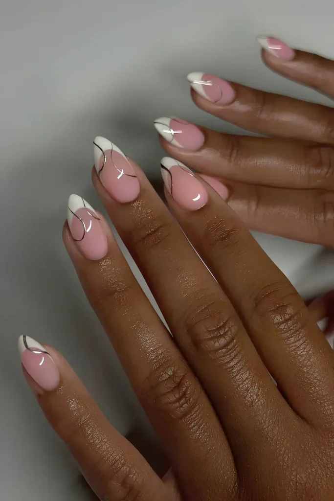 White French tips with chrome swirl accents