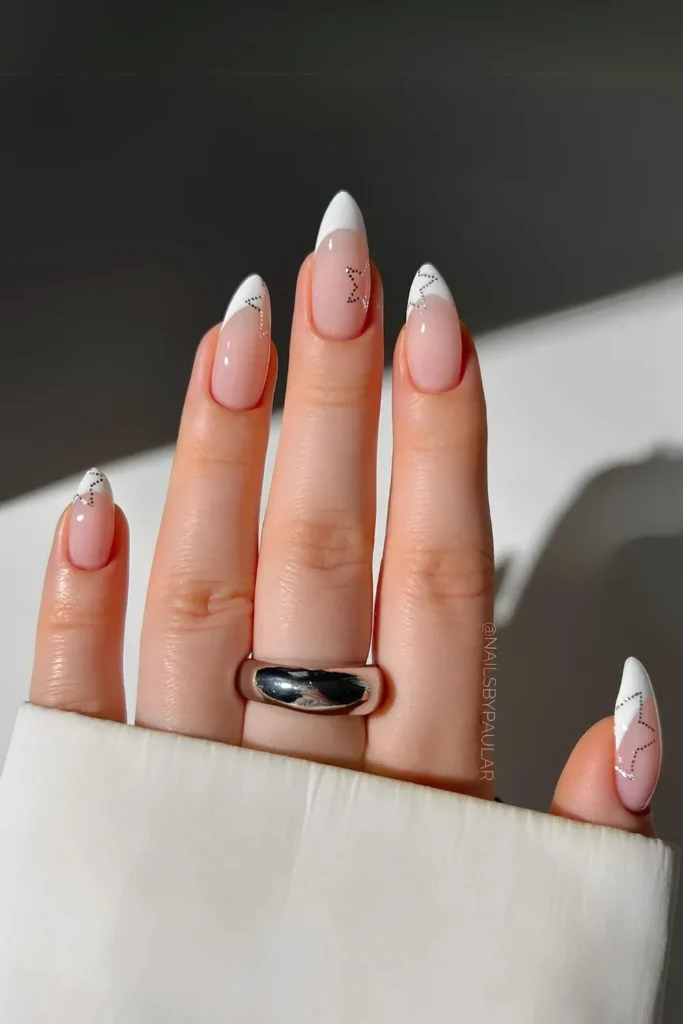 French manicure with white tips and star nail art accents